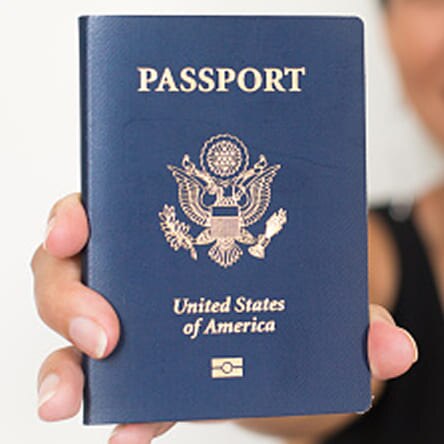 A person holds up their passport.