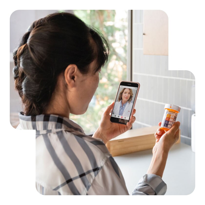 A customer on a telehealth call at home talks to their provider about their prescriptions.